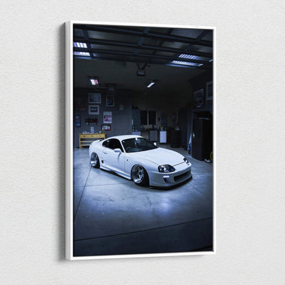 Vertical canvas wall art featuring a white Toyota Supra MK4 in a dimly lit garage setting.