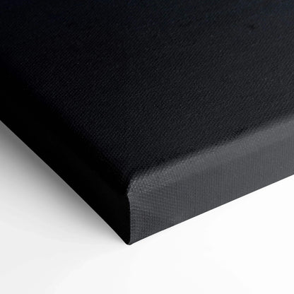 Close-up of black canvas texture and wrapped edge of vertical canvas art wall print.