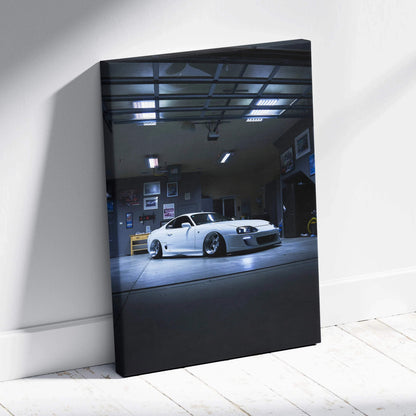 Toyota Supra MK4 car canvas art in a dimly lit garage, modern automotive wall art.