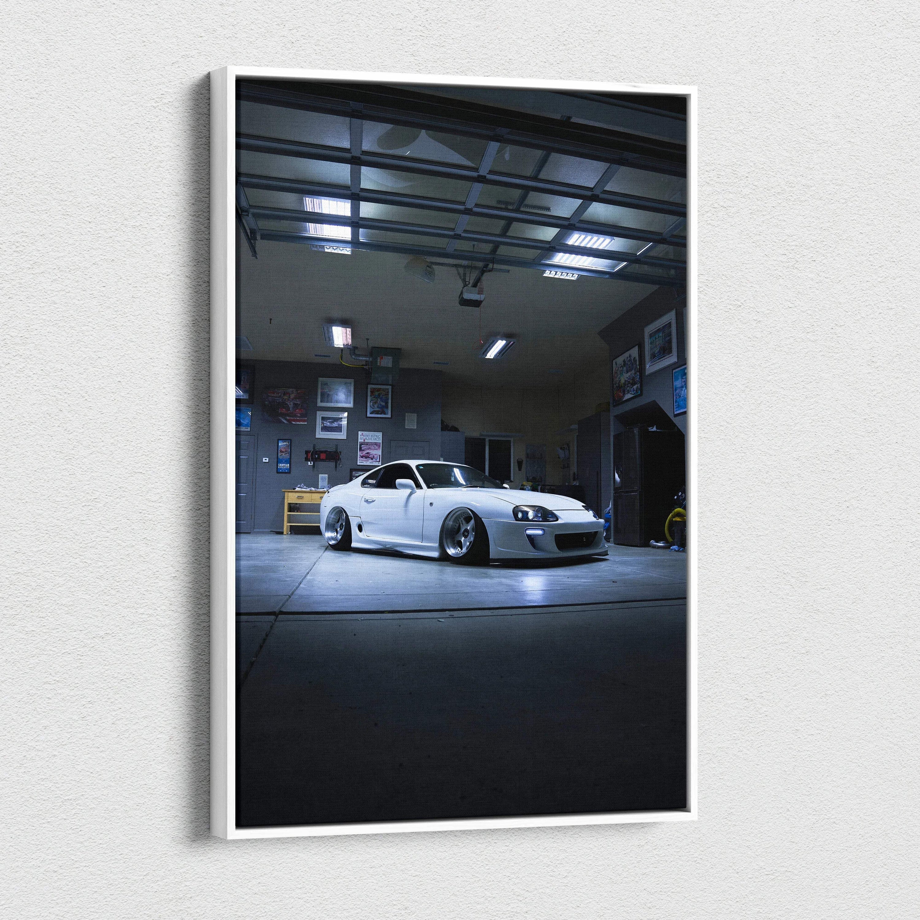 Toyota Supra MK4 in dim garage setting on vertical canvas wall art.