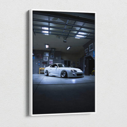 Toyota Supra MK4 in dim garage setting on vertical canvas wall art.