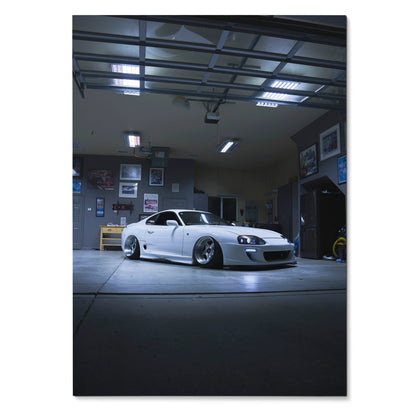 White Toyota Supra MK4 parked in dimly lit garage poster wall art with automotive decor.