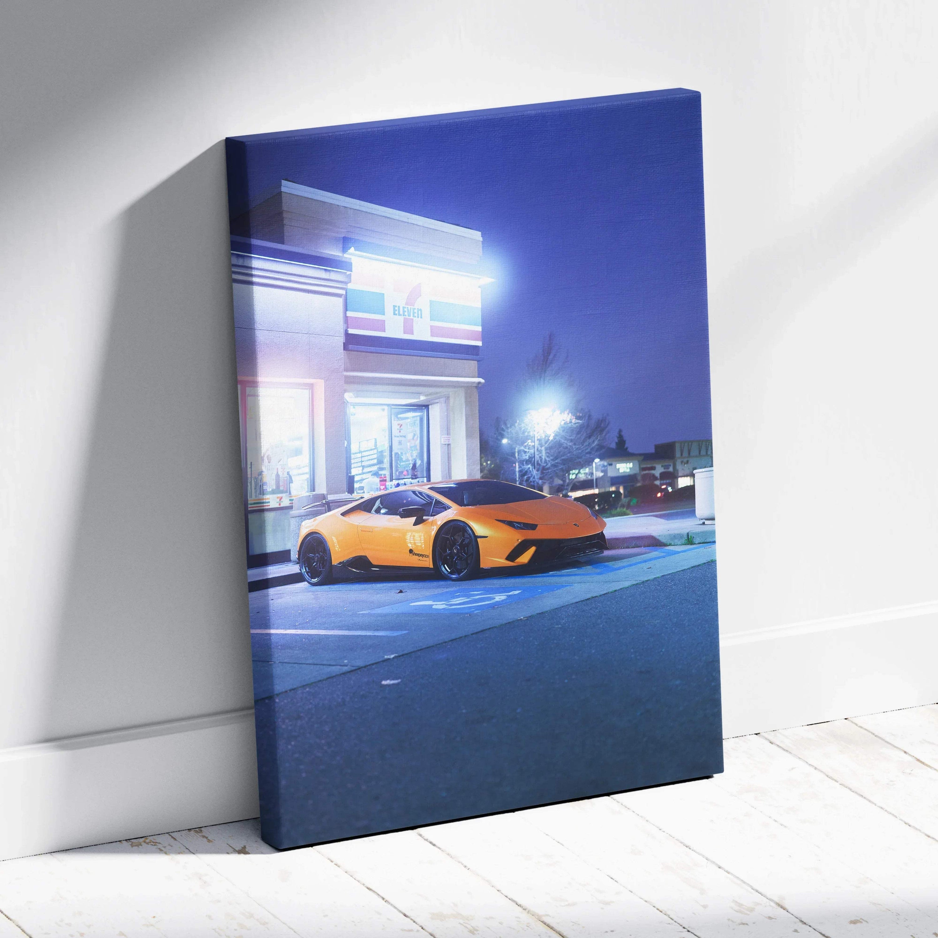 Vertical canvas wall art featuring a bright orange Lamborghini Huracan at night on city street.