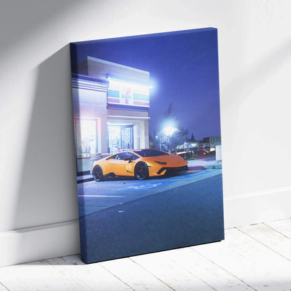 Vertical canvas wall art featuring a bright orange Lamborghini Huracan at night on city street.