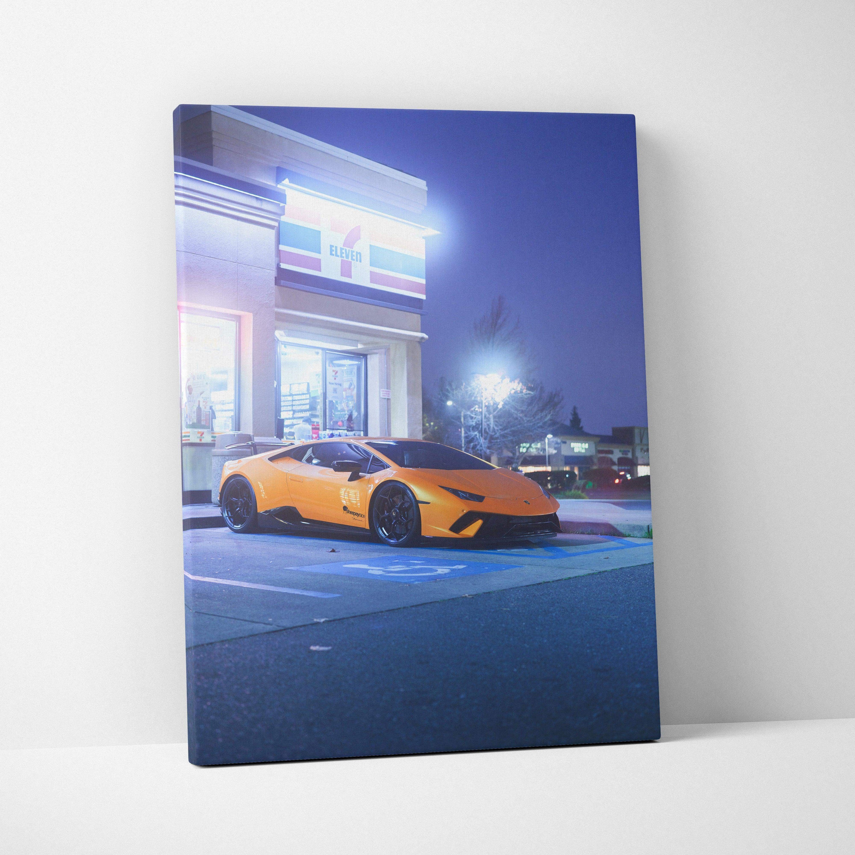 Lamborghini Huracan orange sports car at night canvas wall art with modern building backdrop.