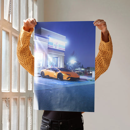 Lamborghini Huracan in vibrant orange parked under bright lights poster wall art with urban night background.