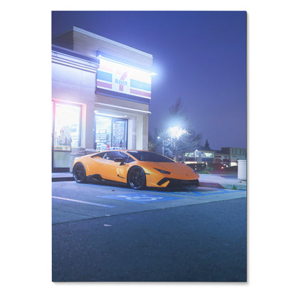 Lamborghini Huracan parked in front of lit modern building at dusk poster wall art.