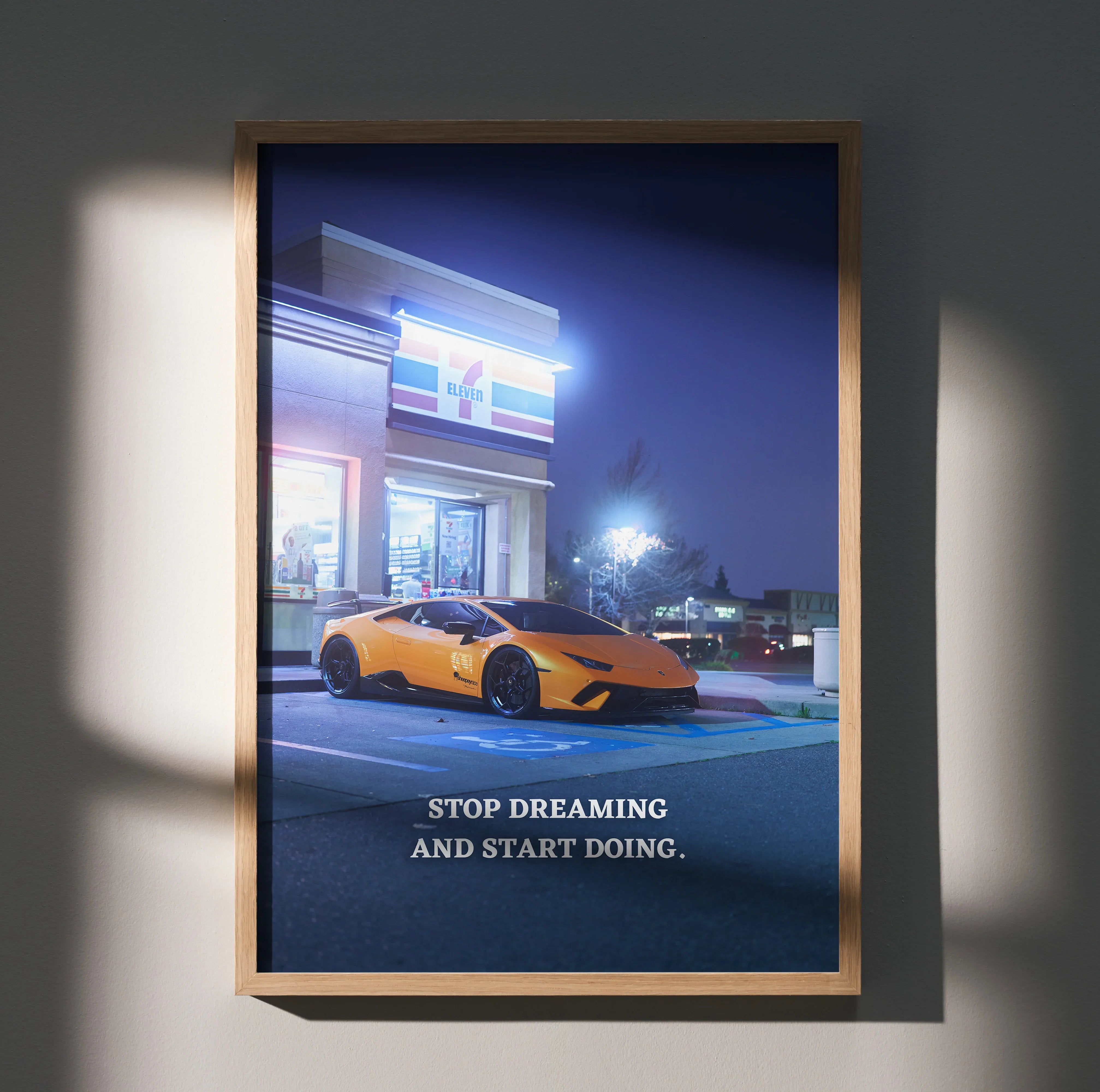 Motivational poster featuring orange Lamborghini Huracan parked by illuminated building at night with "Stop Dreaming and.