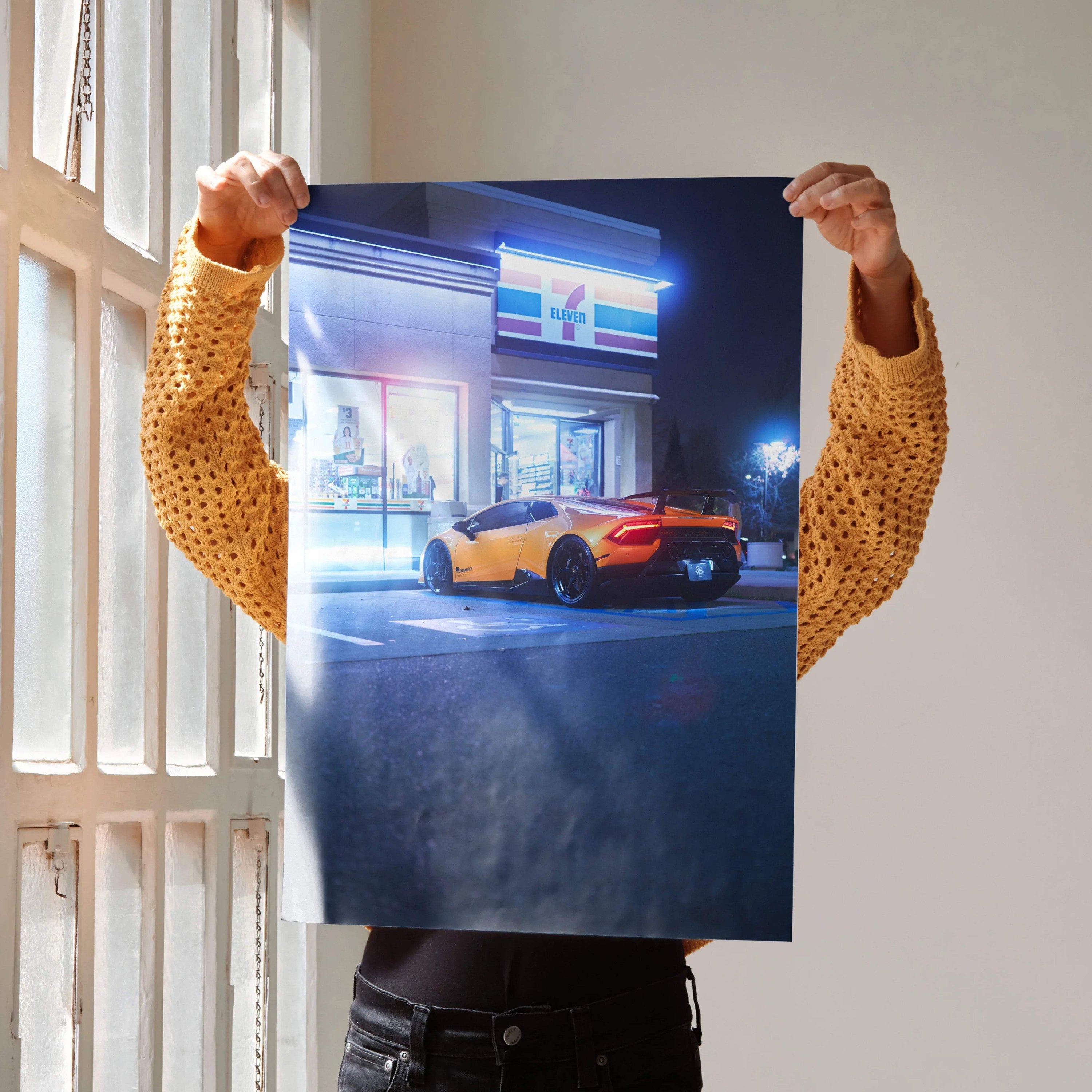 Lamborghini Huracan parked outside a neon-lit building at night poster wall art.