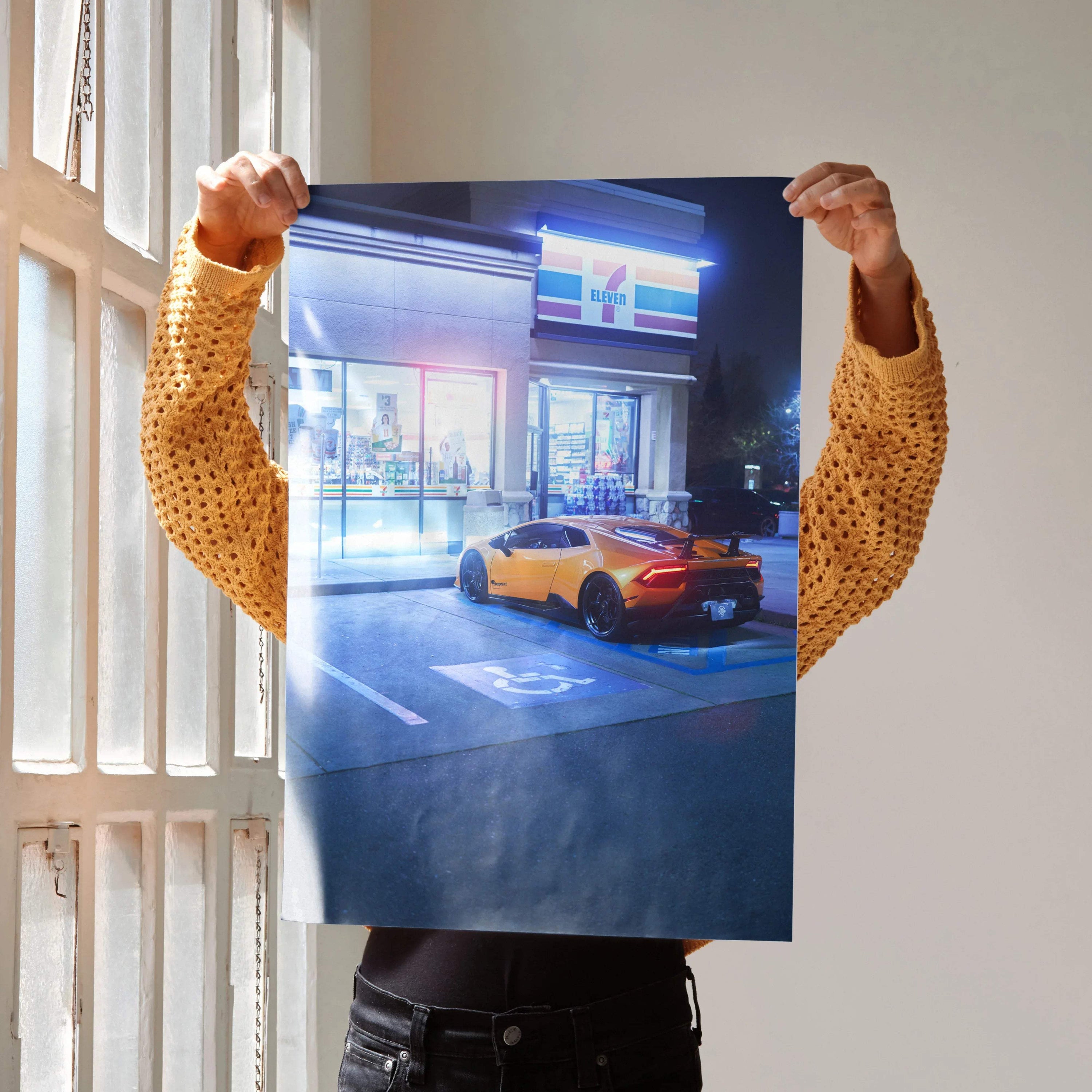 Lamborghini Huracan parked outside illuminated building at night poster wall art.