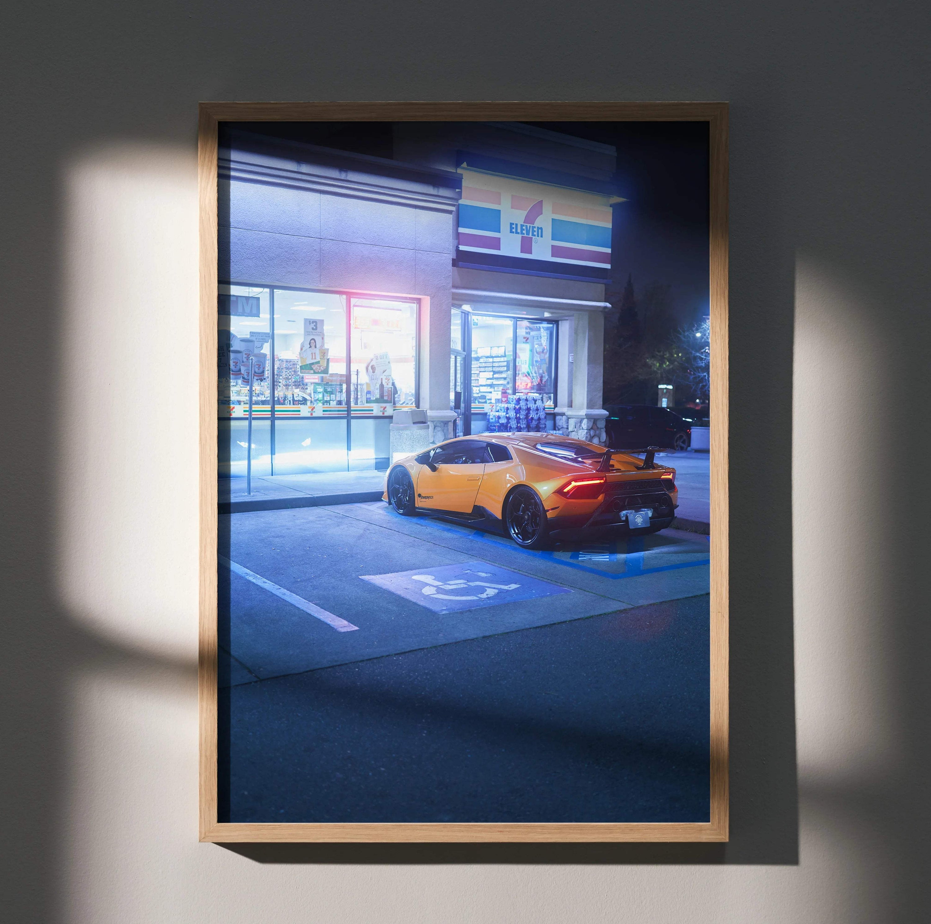 Lamborghini Huracan parked outside convenience store at night poster wall art in wooden frame.