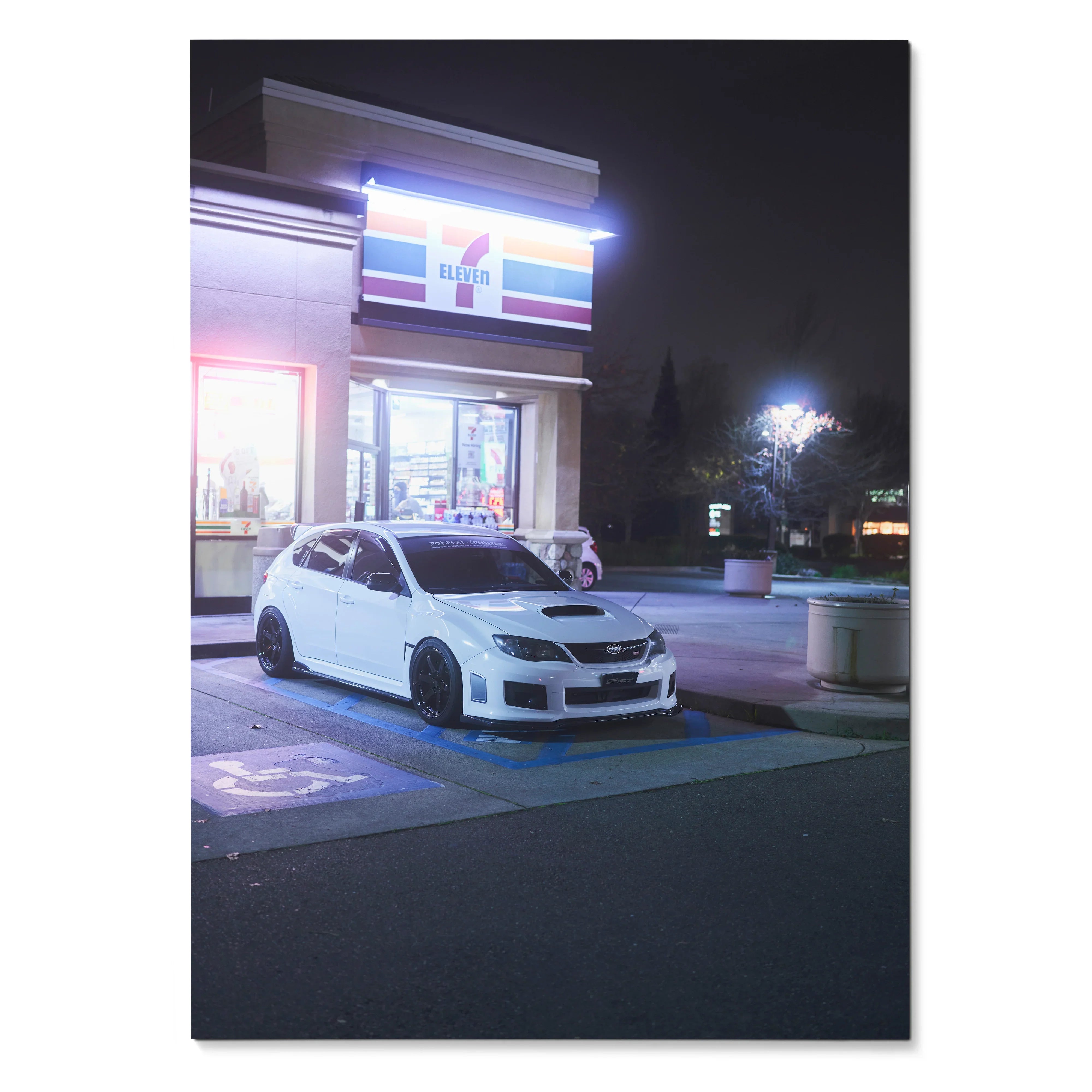 Subaru WRX STI parked at night outside illuminated 7-Eleven store poster wall art.