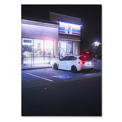 White Subaru WRX STI parked outside illuminated 7-Eleven at night poster wall art.