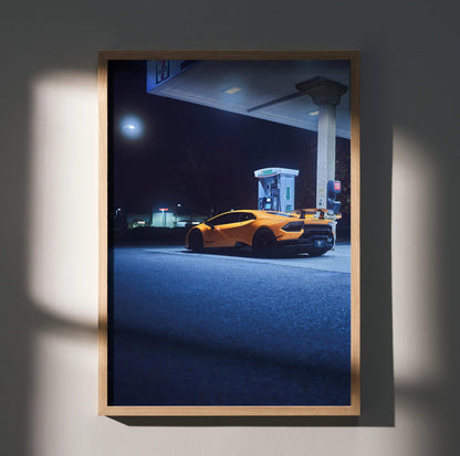 Lamborghini Huracan poster showing orange sports car at gas station under moonlight wall art.