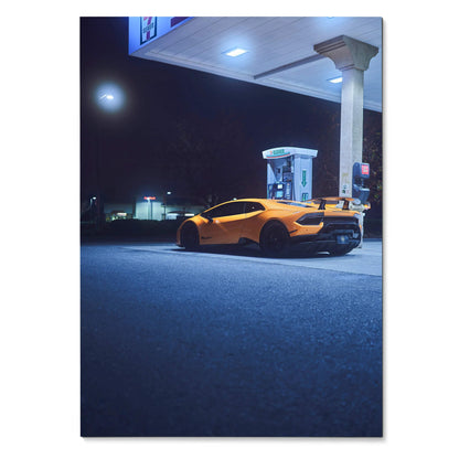 Lamborghini Huracan parked at gas station at night poster wall art in deep blue tones.