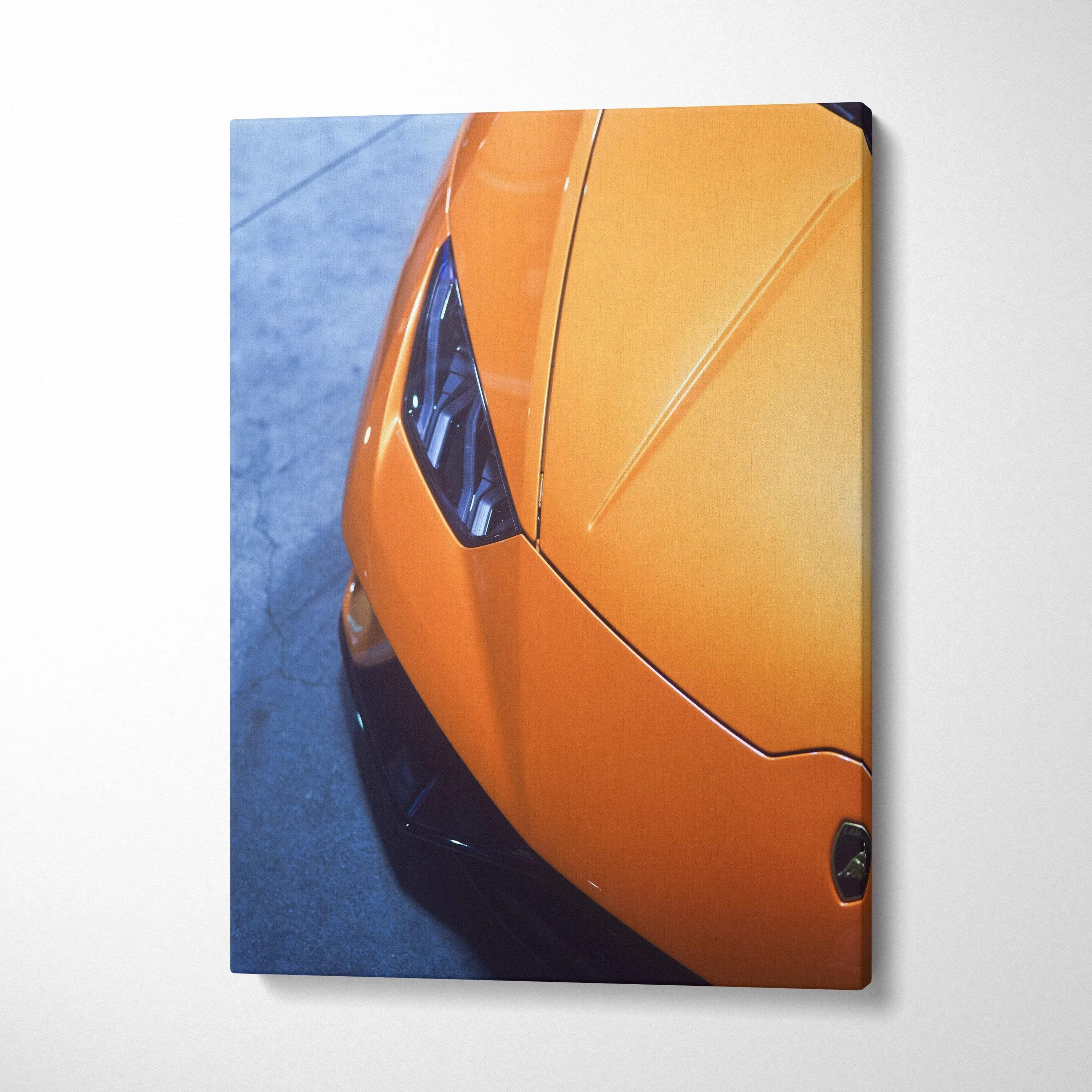 Orange Lamborghini Huracan close-up detail on vertical canvas wall art with sharp shadows.