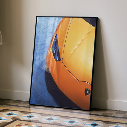 Lamborghini Huracan close-up poster with vibrant orange car front on textured blue background wall art.