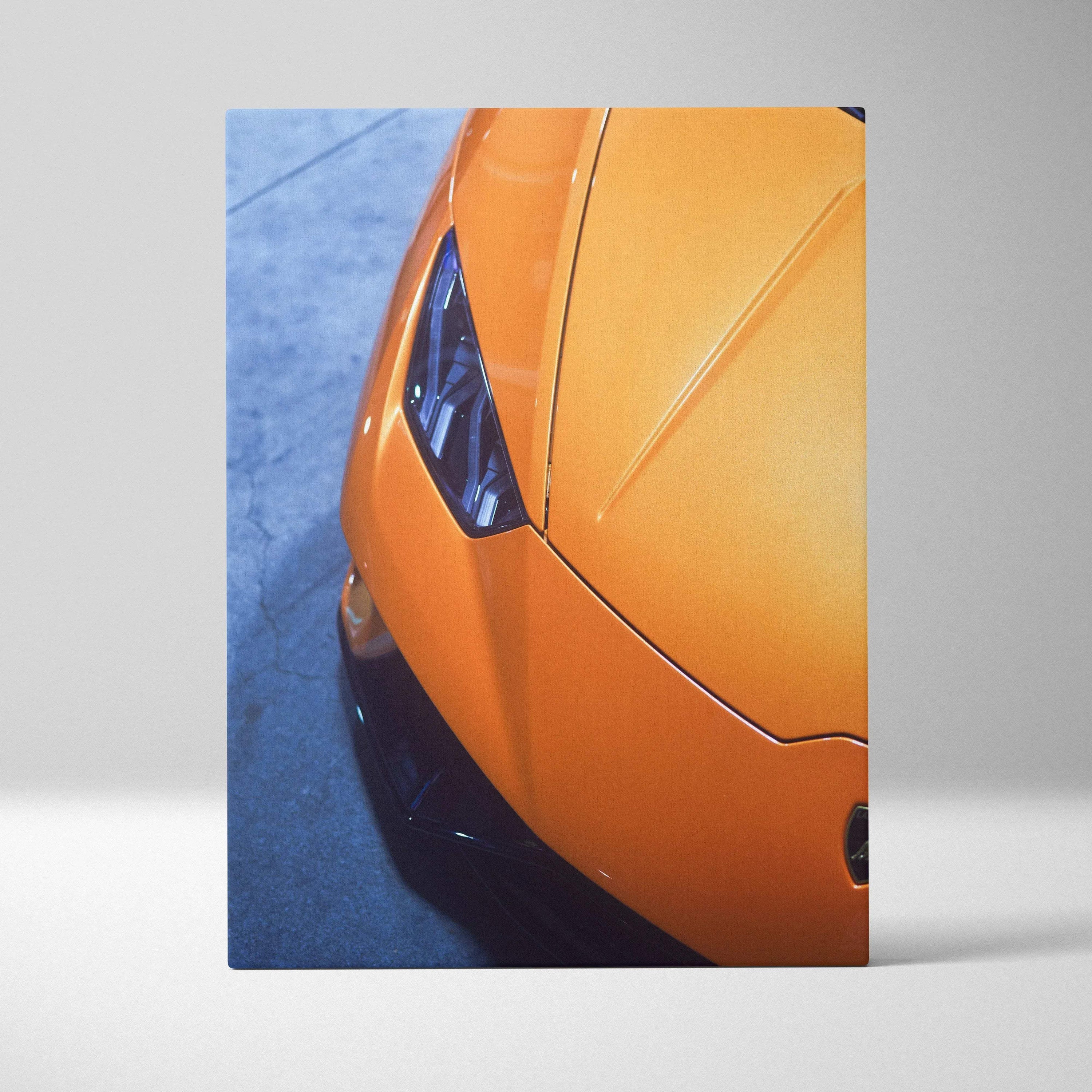 Orange Lamborghini front detail canvas art with sharp headlights and sleek hood, vertical wall art.