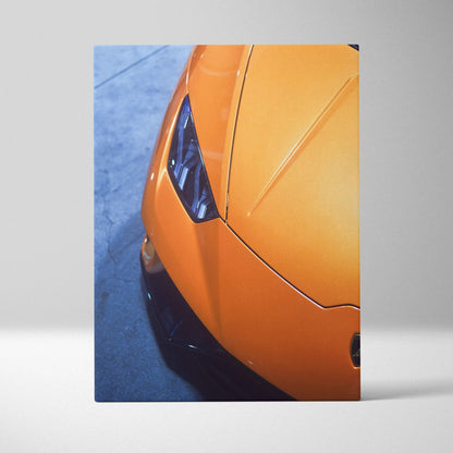 Orange Lamborghini front detail canvas art with sharp headlights and sleek hood, vertical wall art.