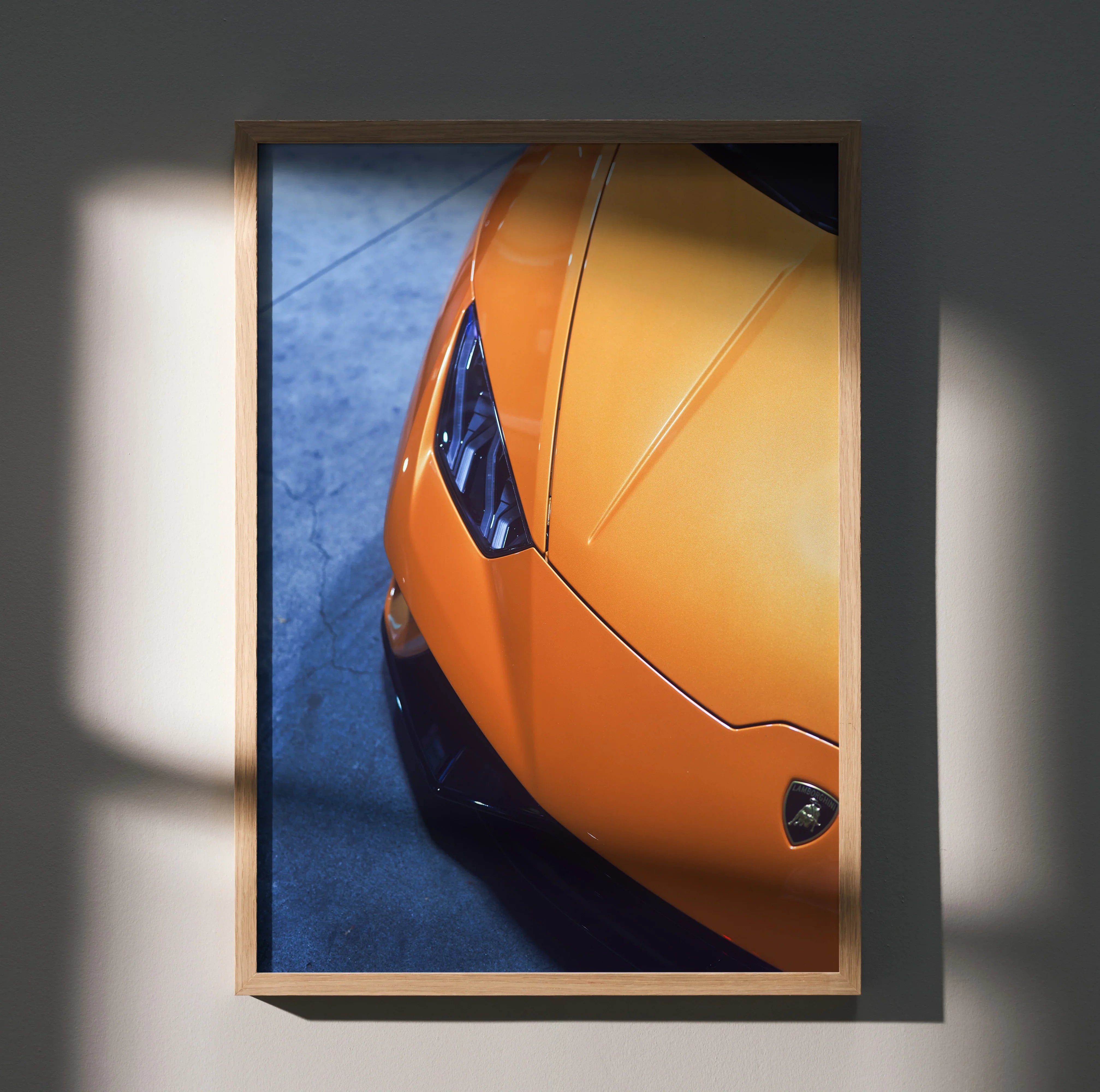 Orange Lamborghini Huracan close-up poster wall art in wooden frame, glossy finish, displayed with shadows.