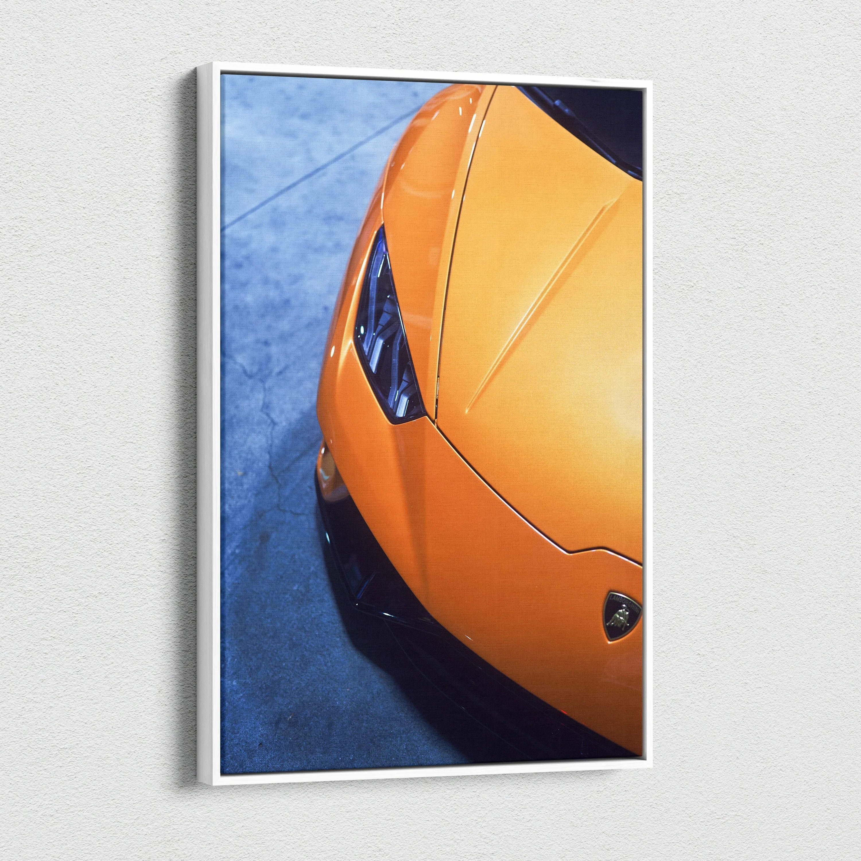 Orange Lamborghini Huracan close-up canvas art with sleek lines and sharp headlights on blue background wall art.