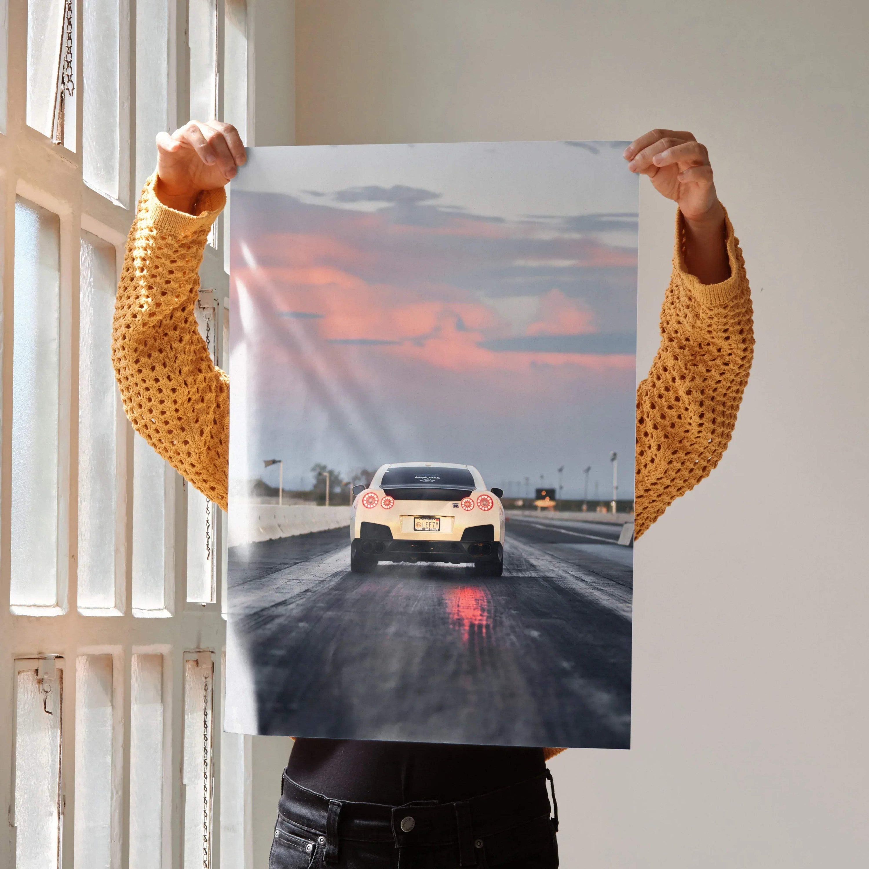 Nissan GTR R35 racing poster wall art with sunset sky and wet track reflections.