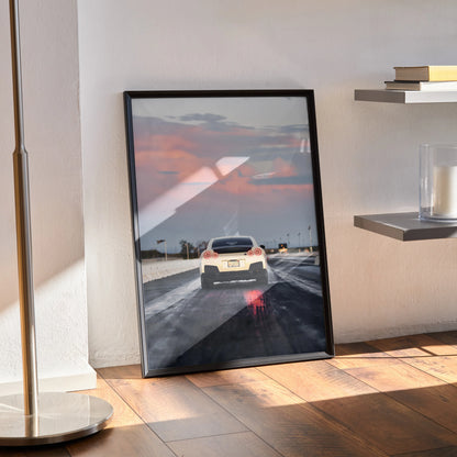 Nissan GTR R35 poster leaning against wall with sunset road background, framed wall art.