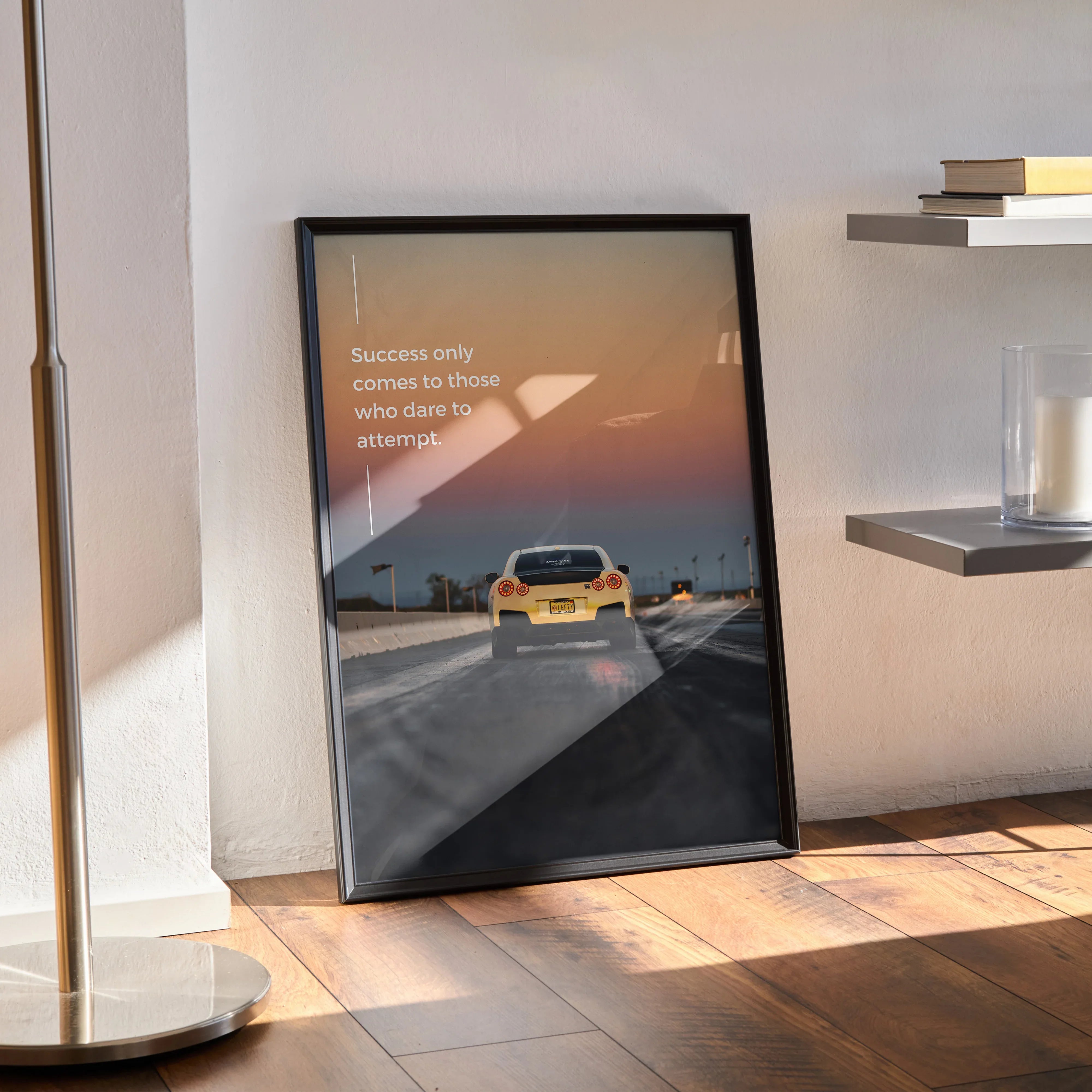 Nissan R35 GT-R poster with motivational quote in black frame leaning against wall, wall art decor.