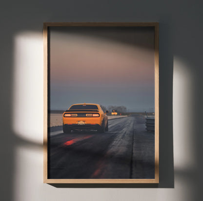 Dodge Challenger poster with vintage muscle car on racetrack at dusk, automotive wall art.