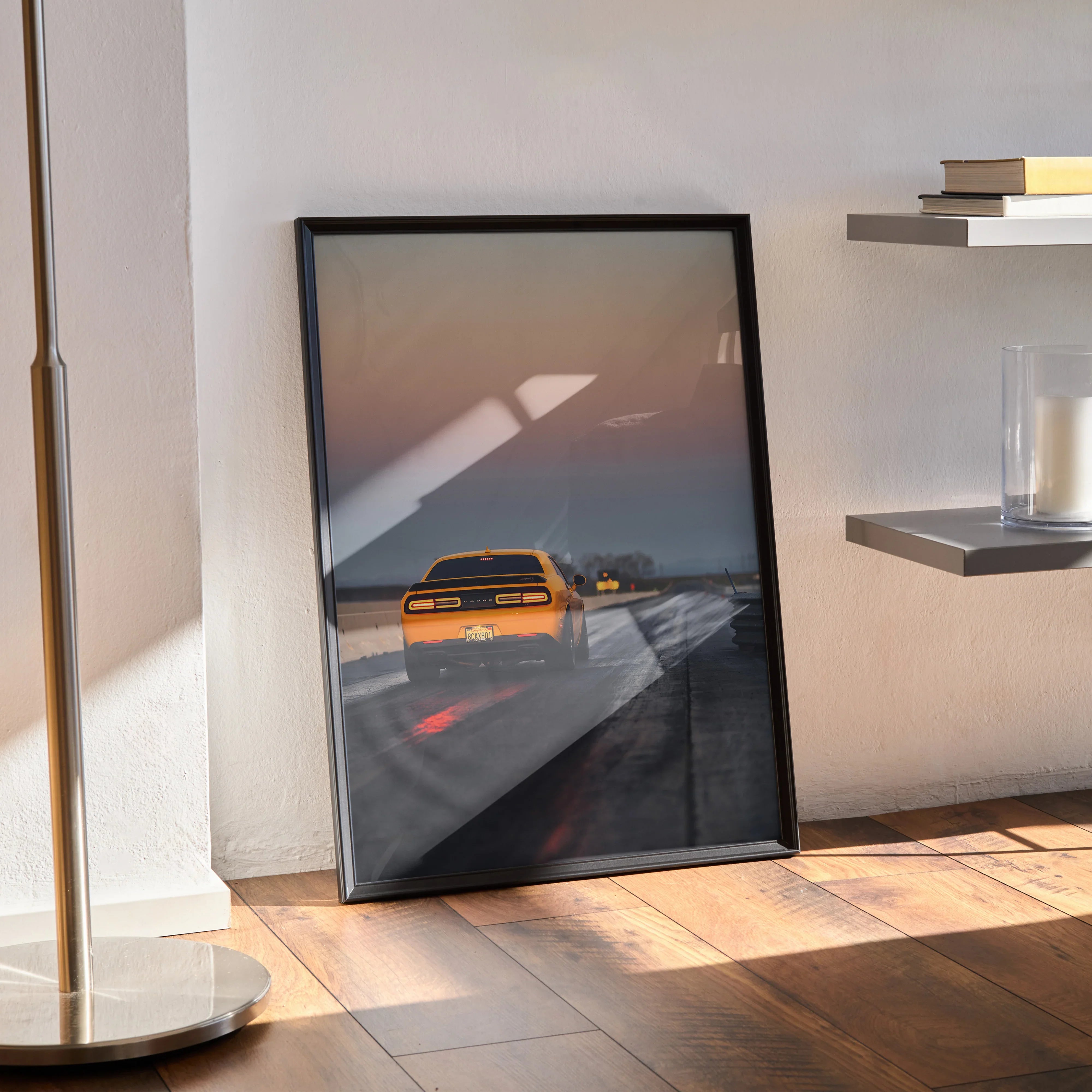 Dodge Challenger poster with yellow muscle car on road, framed wall art in modern room lighting.