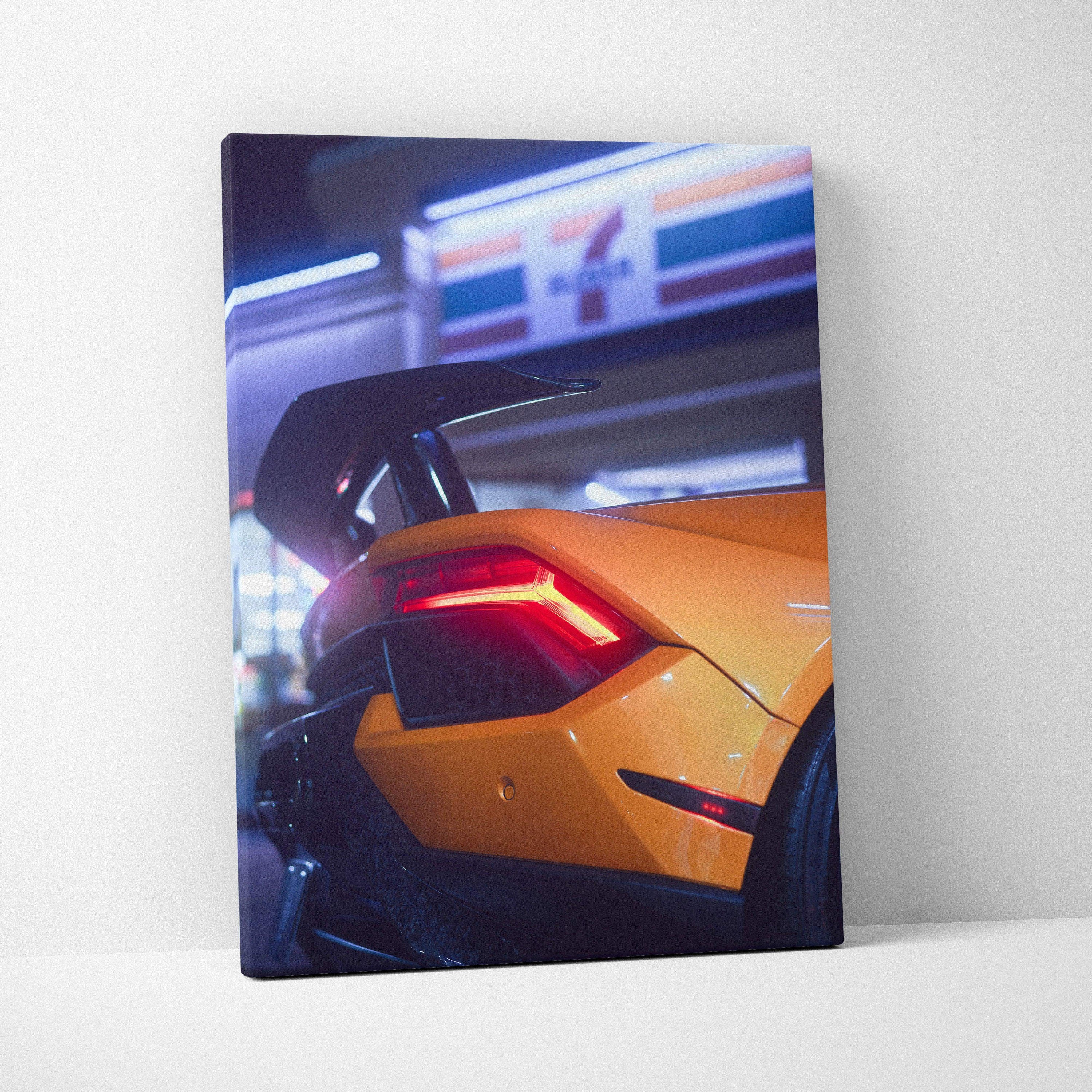 Yellow Lamborghini Huracan rear with illuminated taillight on vertical canvas wall art.