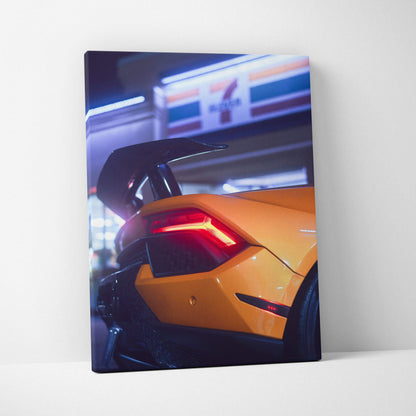 Yellow Lamborghini Huracan rear with illuminated taillight on vertical canvas wall art.