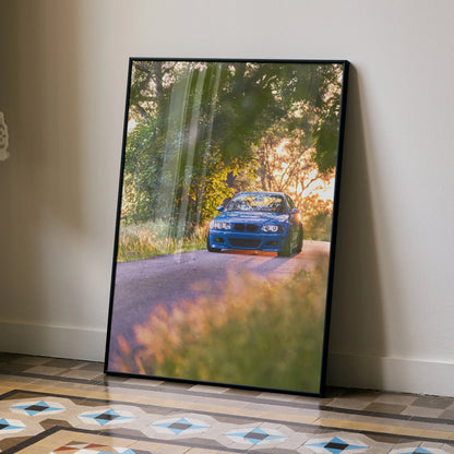 BMW E46 M3 poster showing blue car driving on sunlit forest road, automotive wall art.