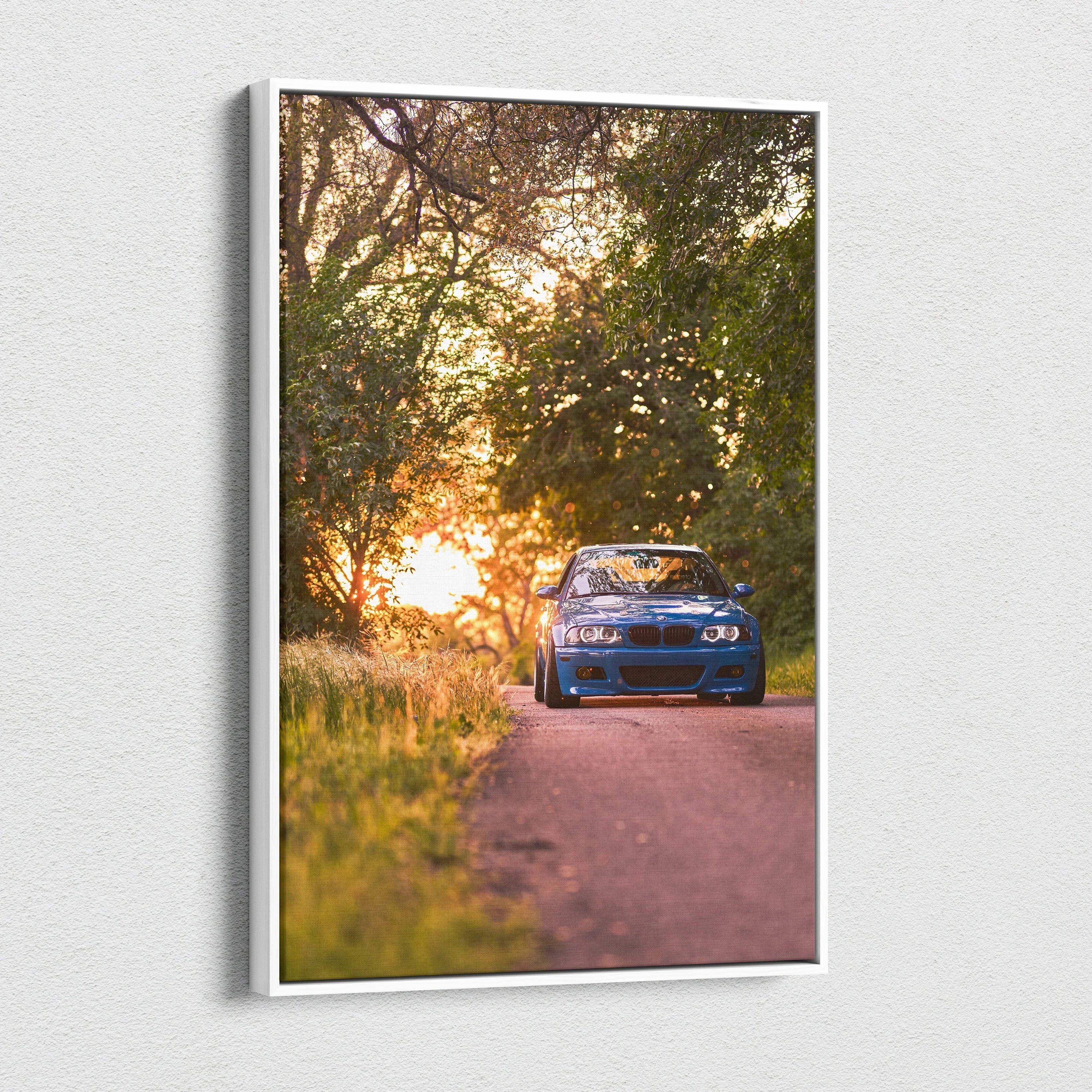 BMW E46 M3 blue car at sunset on vertical canvas wall art with forest background.