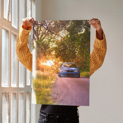 BMW E46 M3 on sunset road poster wall art with vibrant natural lighting and detailed car features.