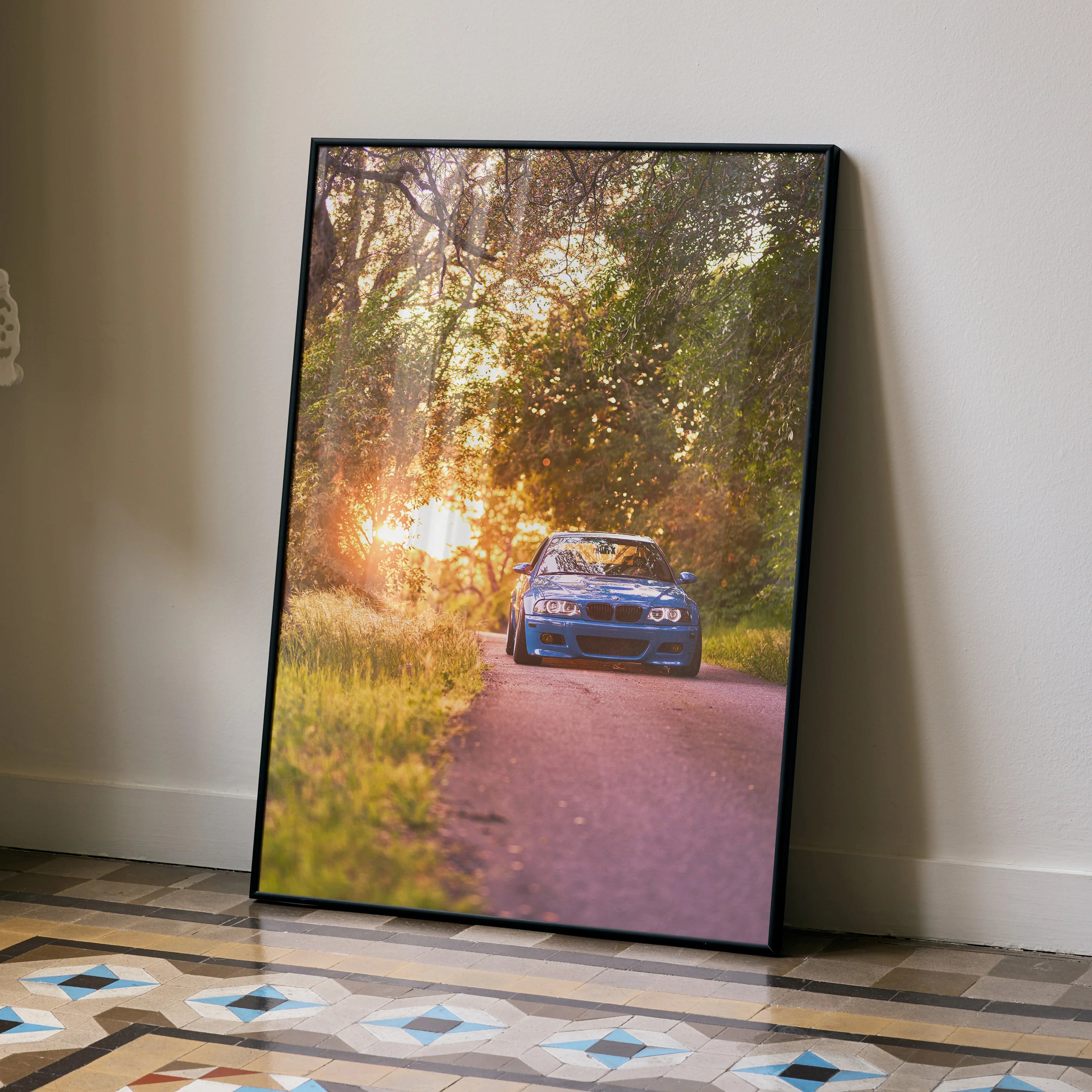 BMW E46 M3 poster wall art featuring a car on a sunset-lit forest road in warm tones.