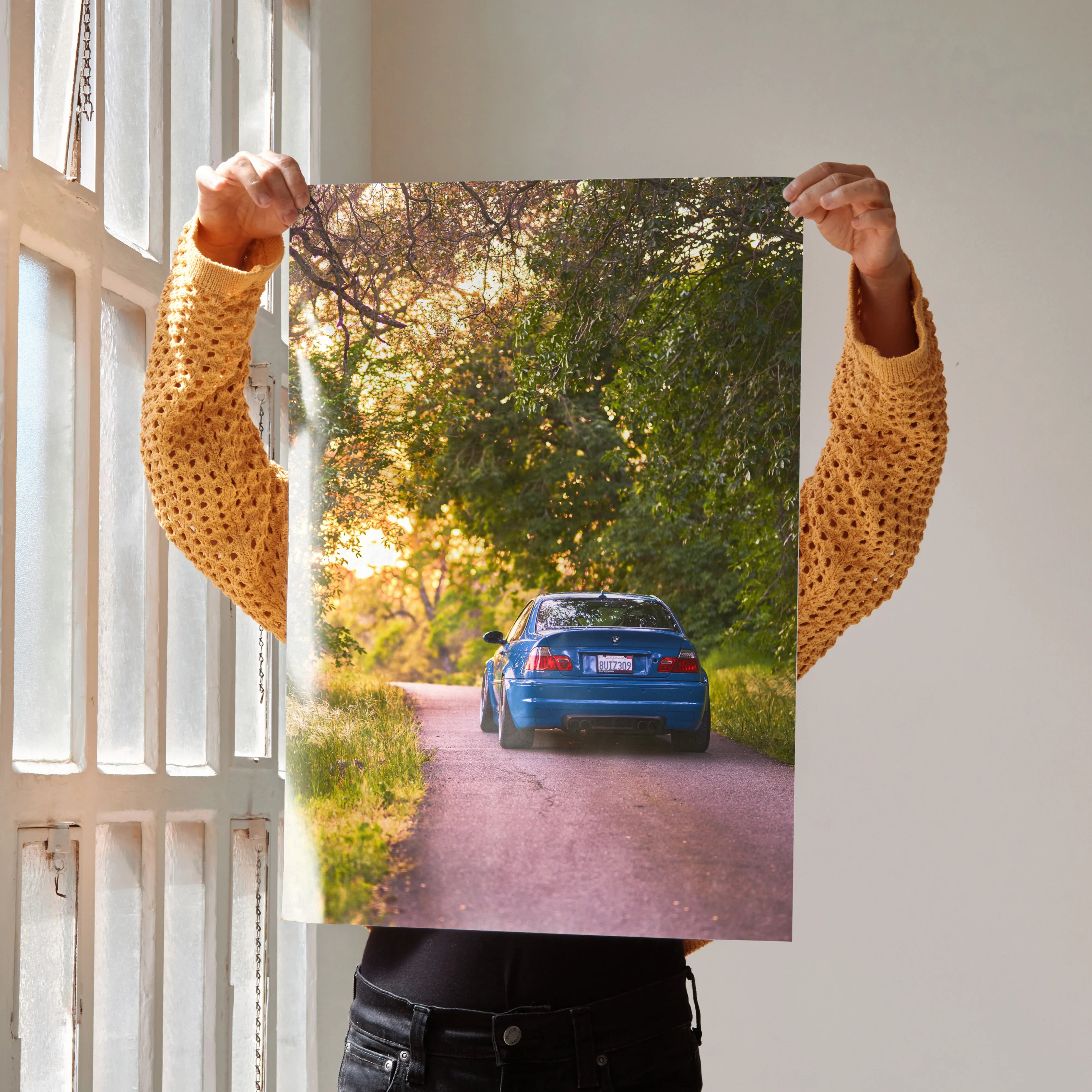 BMW E46 M3 driving on a forest road at sunset poster wall art with vibrant colors.