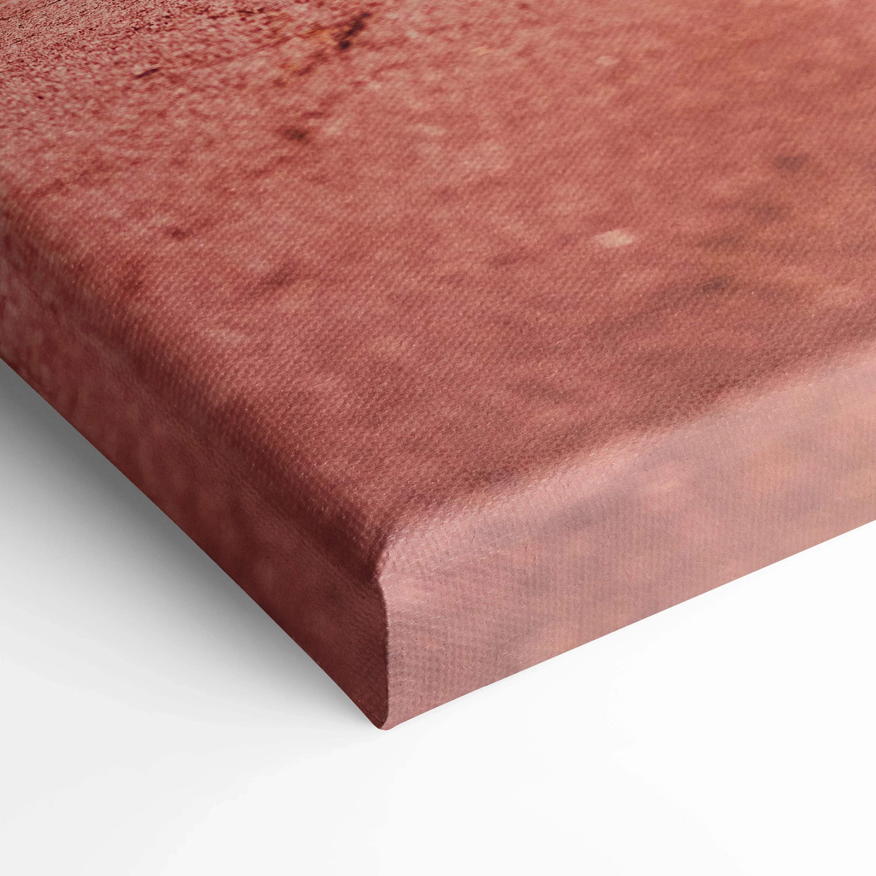 Close-up of textured red canvas wall art corner with museum-quality print finish.
