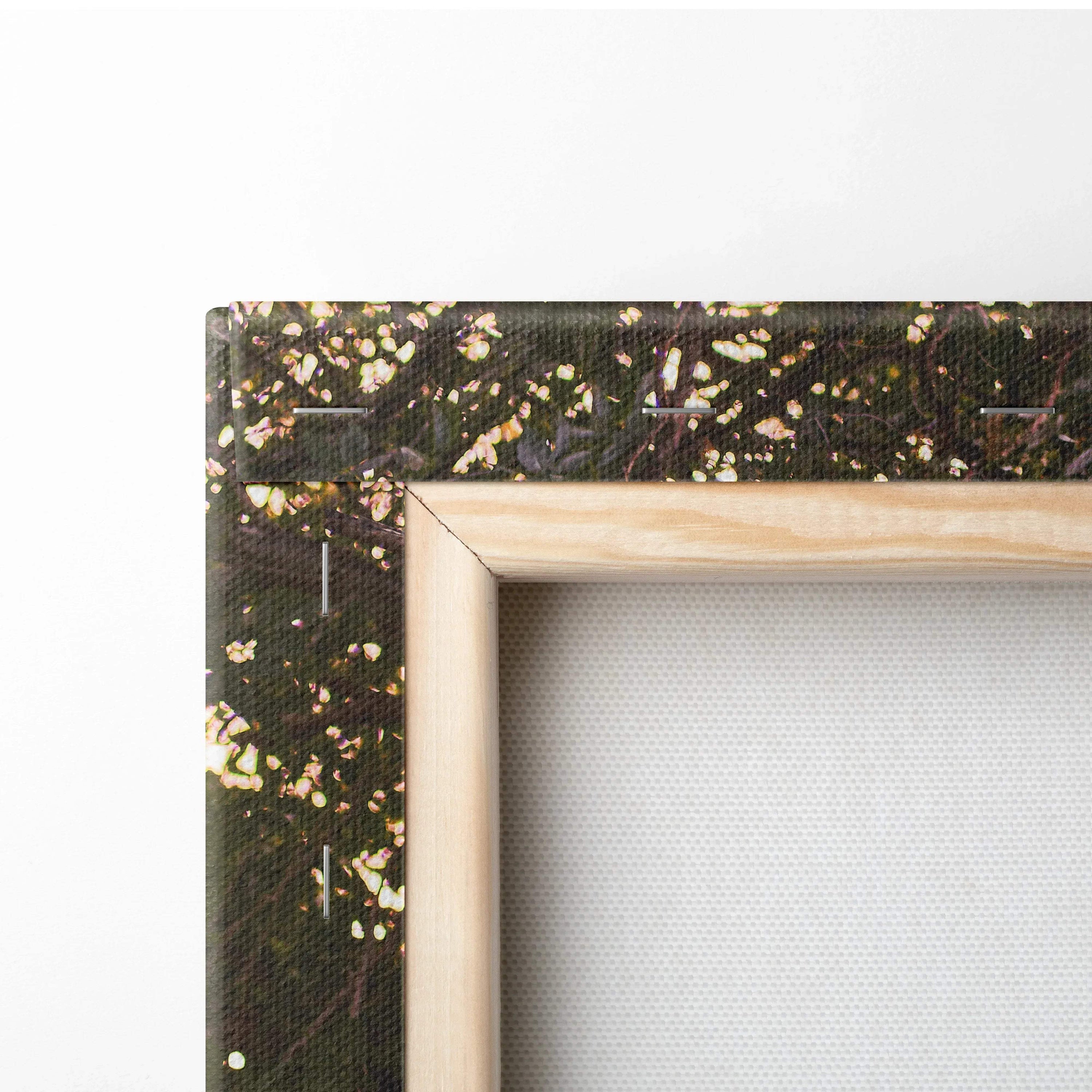 Close-up of wooden frame corner with dark abstract canvas wall art texture.