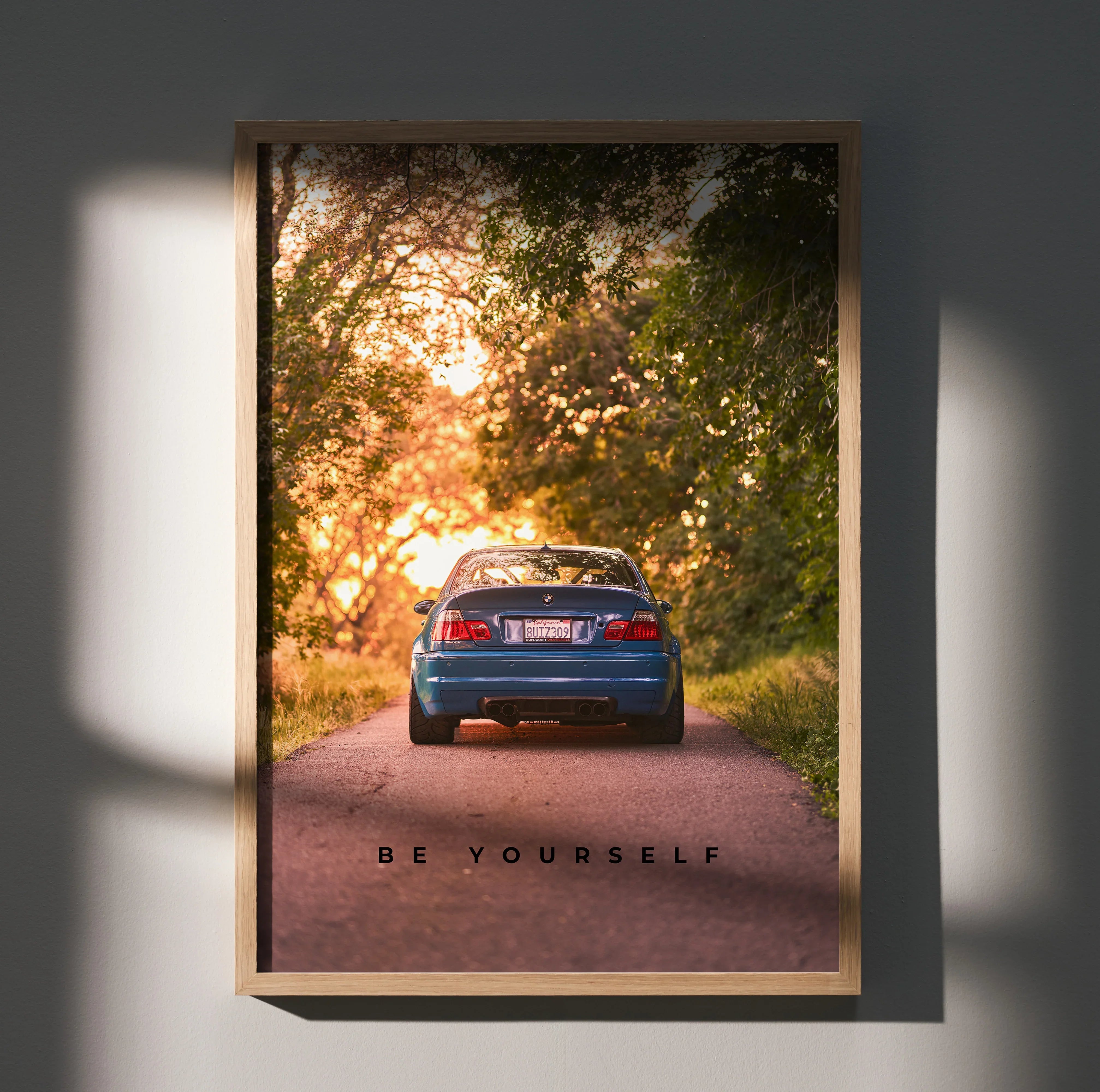 BMW E46 M3 poster wall art showing rear view on forest road with "Be Yourself" text.