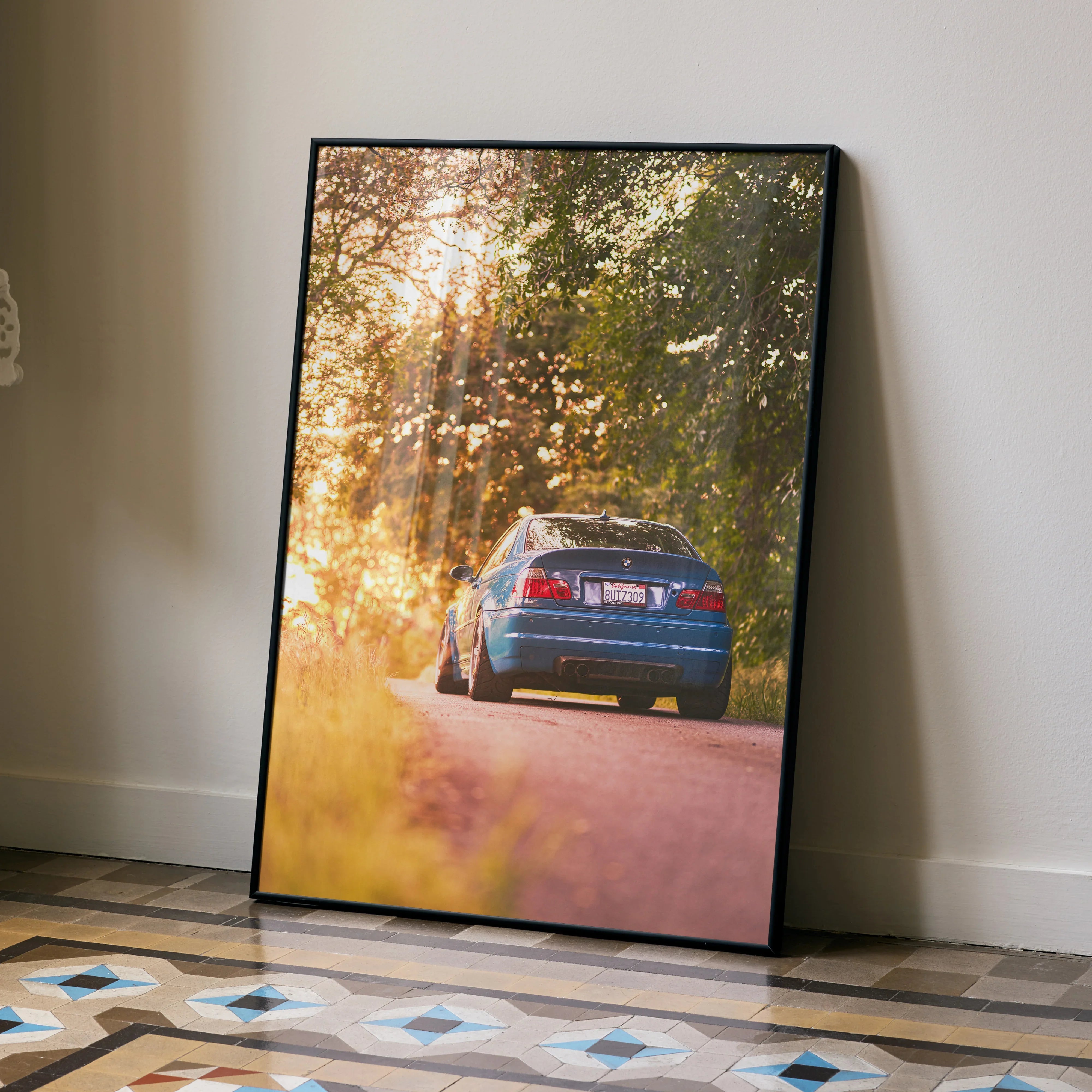 BMW E46 M3 poster wall art with sunset and forest road scene in warm golden light.