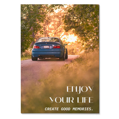 Motivational poster wall art featuring rear view of blue BMW E46 M3 on sunlit forest road with inspiring text.