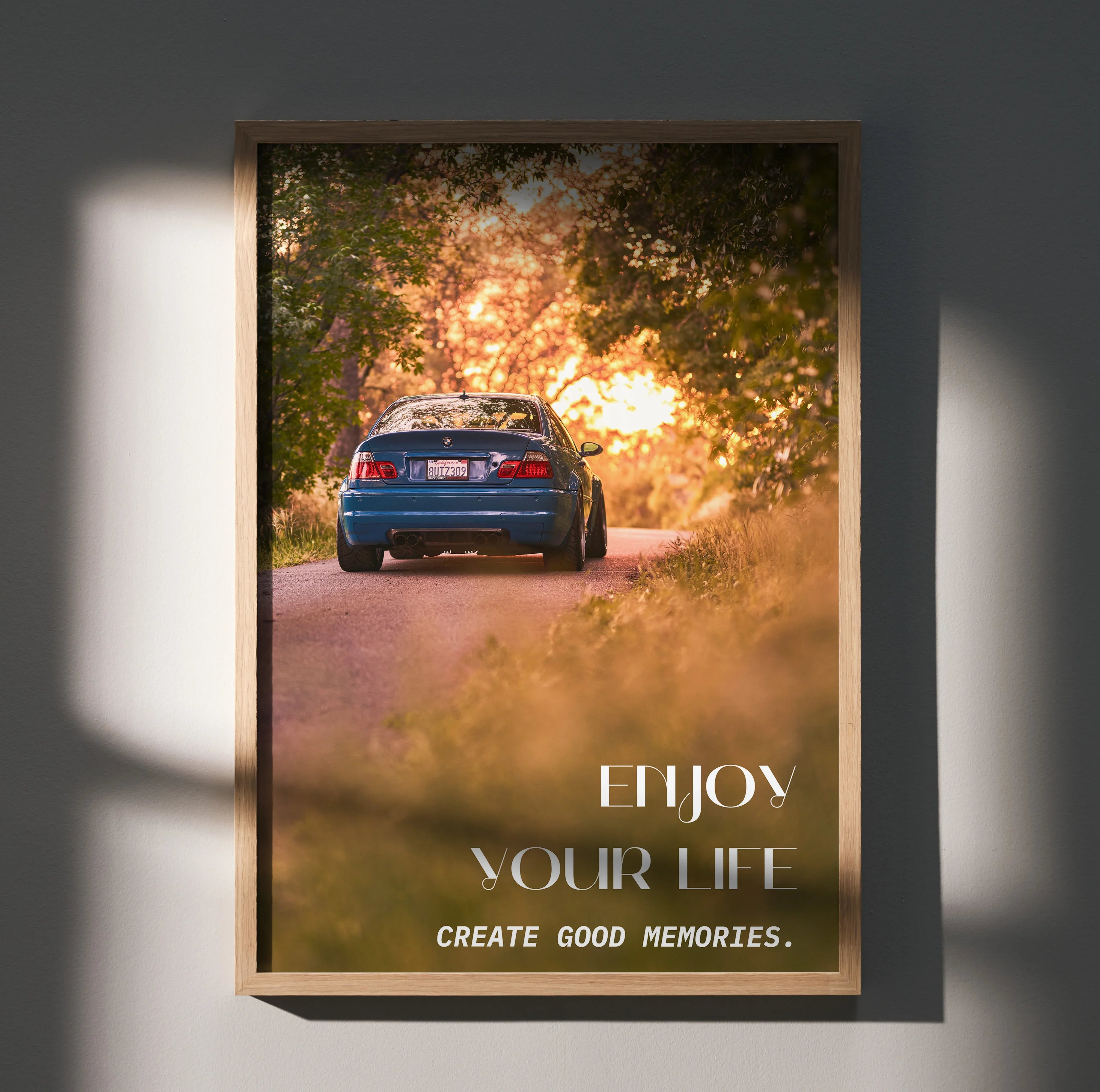 BMW E46 M3 driving on a forest road at sunset motivational poster wall art with inspiring text.