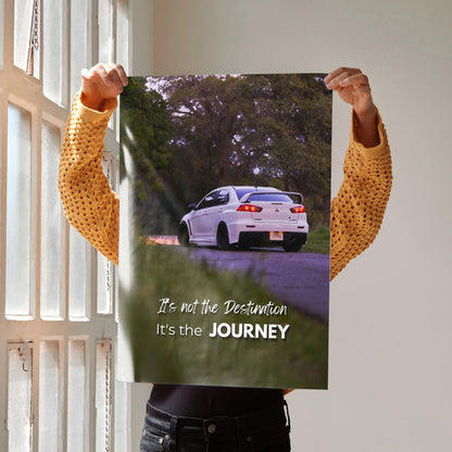 Motivational wall art poster featuring a white Mitsubishi Evo 10 on a winding road with the text "It's not the Destination,.