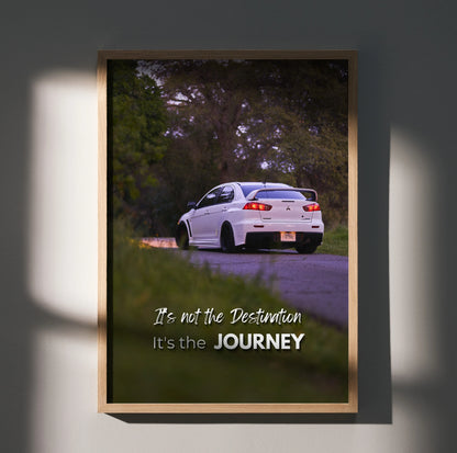 Motivational poster wall art featuring white Mitsubishi Evo 10 on road with inspiring text "It's not the Destination it's.