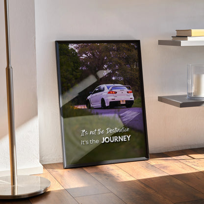 Motivational poster wall art of white Mitsubishi Evo 10 on road with inspiring text on bottom.