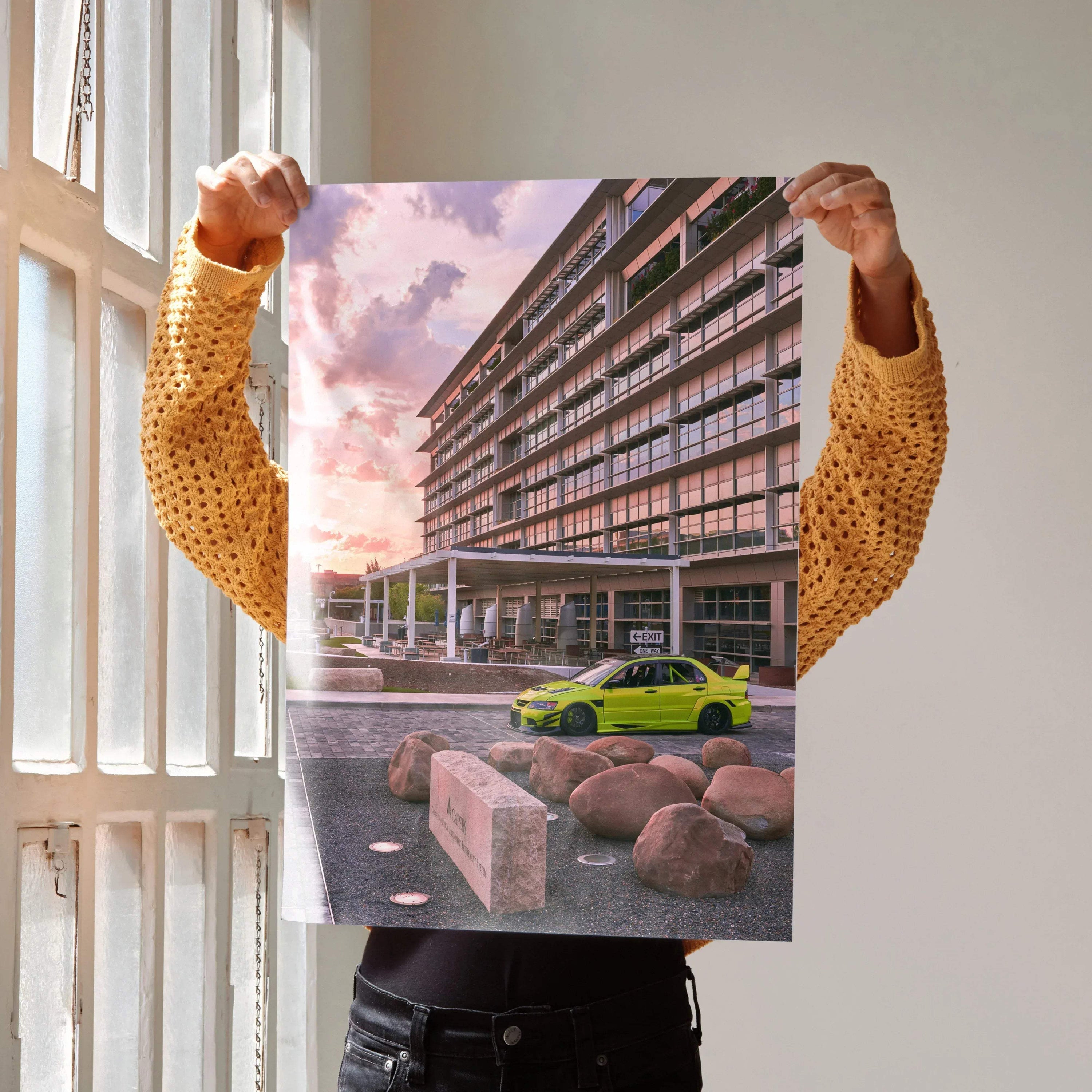 Mitsubishi Evo 9 poster wall art featuring bright green car parked by modern building under pastel sunset sky.