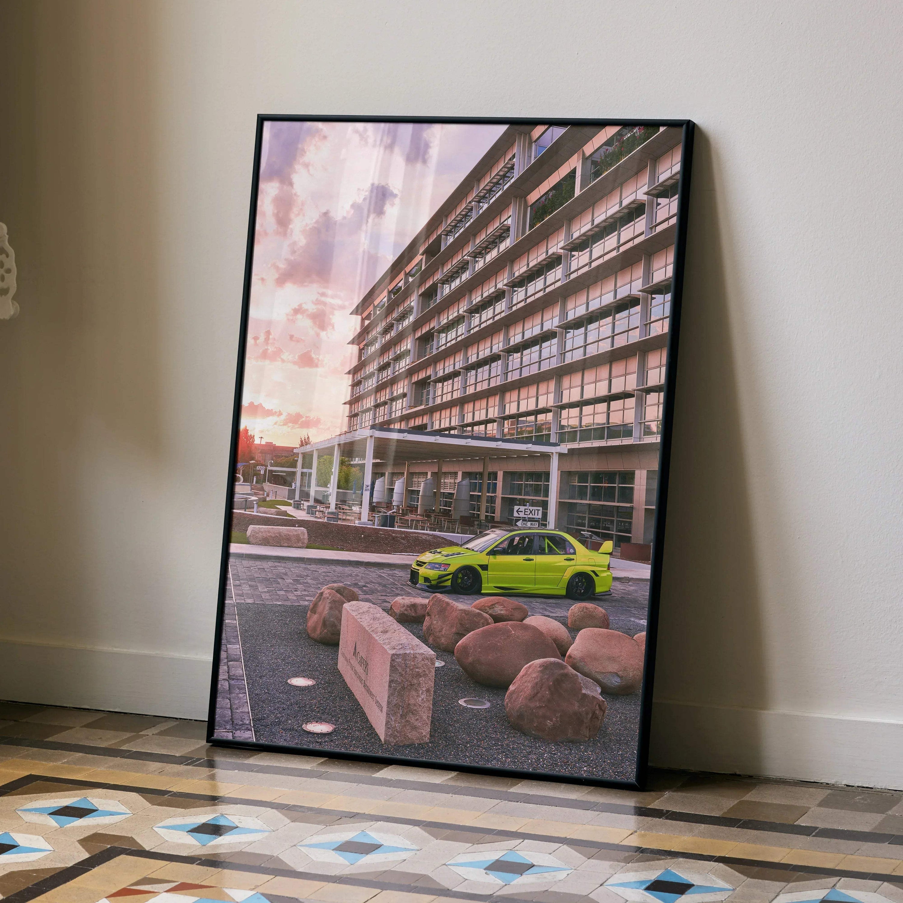 Mitsubishi Evo 9 in bright lime green parked by modern building at sunset poster wall art.