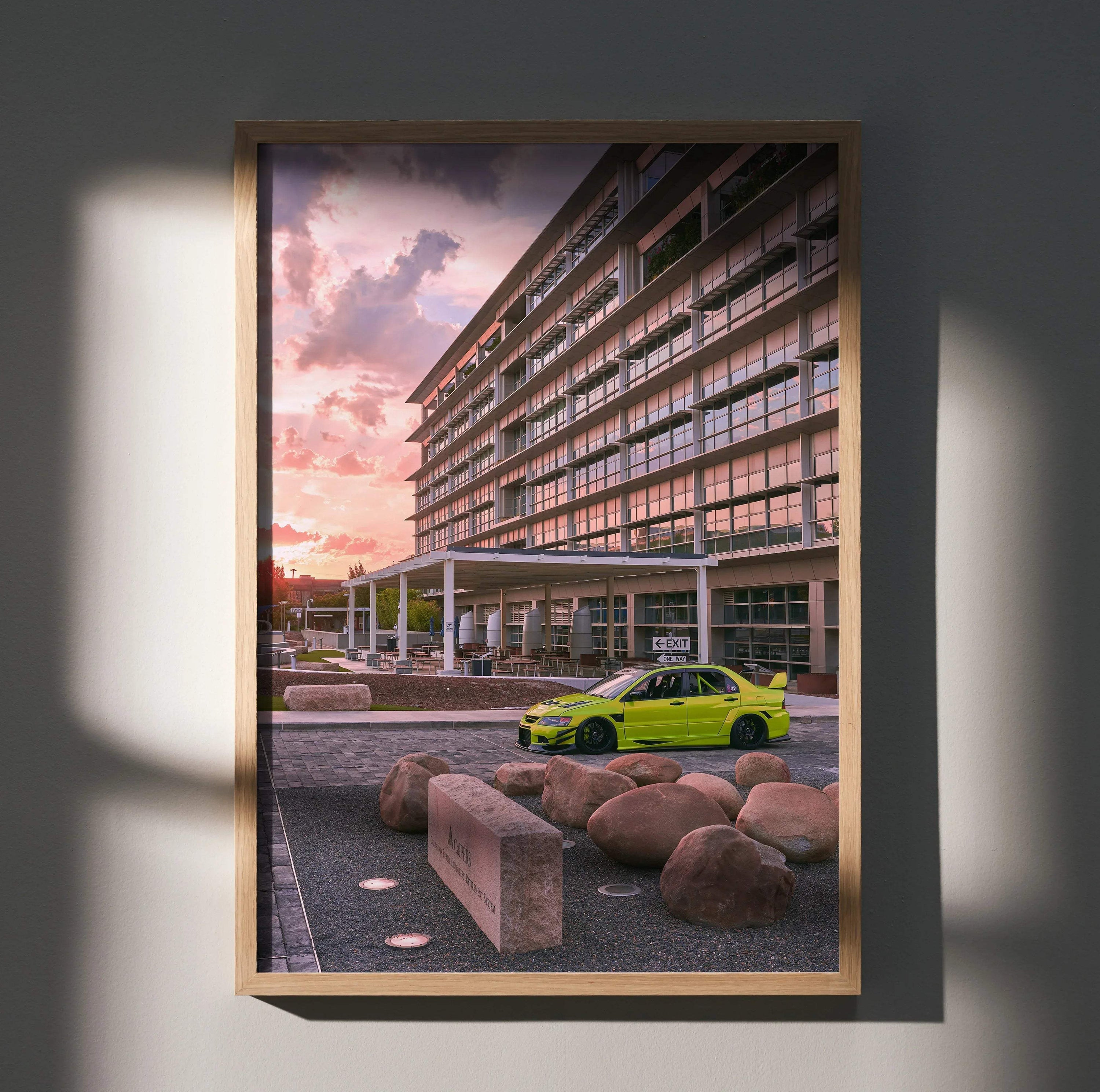 Mitsubishi Evo 9 in bright green parked by modern building at sunset poster wall art.