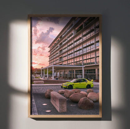 Mitsubishi Evo 9 in bright green parked by modern building at sunset poster wall art.